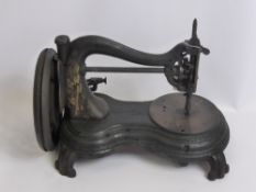 An 1880 Cast Iron Jones Patent Serpentine Hand Sewing Machine.