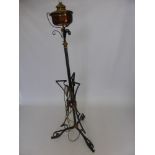 A Copper and Wrought Iron Lamp Stand, converted from an oil lamp with a lamp shade.
