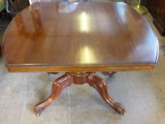 A Mahogany Tilt Top Supper Table with turned column on carved legs with castors, approx 101 x 85 x