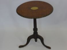 An Antique Oak Wine Table, the table on turned column with carved tripod base, the top with