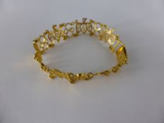 A Lady's 21 ct Yellow Gold Design Link Bracelet, in the form of leaves and bows, safety chain,