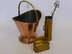 A Hammered Copper Coal Scuttle together with three Fireside Implements housed in a brass mortar