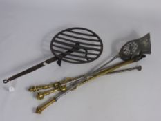 A Large Antique Cast Iron Trivet together with brass fire irons and coal shovel.