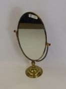 An Oval Brass Dressing Table Mirror.
