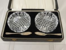 A Pair of Cut Glass Butter Dishes and silver butter knives together in the original box together