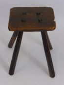 An Antique Oak Milking Stool, on four straight legs.