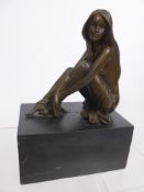 A Bronzed Figure of a Girl with long flowing hair seated on marble plinth, approx 24 x 17 x 11 cms.