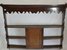 An Antique Oak Three Shelf Dresser Top, having a decorative wave form frieze with central spice