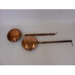 Two Copper Bed Warmers, both with turned handles.