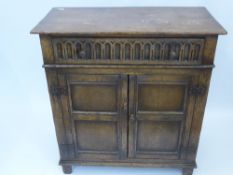 An Antique Oak Cupboard with single drawers and two cupboards beneath, approx 85 x 41 x 90 cms.