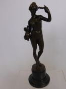 A Bronzed Statue of a Girl holding a vase of flowers and a laurel coronet, signed by A. le Vries,