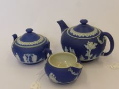An Antique Wedgwood Jasper Ware Teapot, milk jug and sugar bowl. Impressed marks to base.