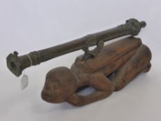 A Malaysian Bronze Lantaka Cannon, circa 1800 on original carved wooden base, overall length 73