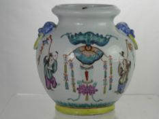 A Chinese Porcelain Pot depicting figures waving decorated tasseled wands and a Chinese lantern