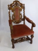 An Oak Framed Hall Chair, with decorative carving to back and elbow rests, on turned legs and