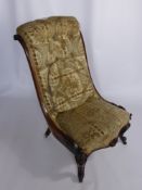 An Edwardian Bath Chair on carved legs with porcelain casters.