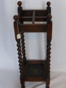 A Wooden Umbrella Stand, with turned legs and four round corner finials, approx 70 x 24 x 24 cms.