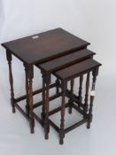 A Mahogany Nest of Three Tables on turned legs with straight stretchers.
