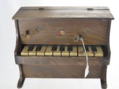 A Miniature Wooden 10 Key Piano, with tiny candelabra and the melody of "Tipperary" in the lid,