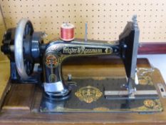 A Frister & Rossmann Sewing Machine in Wooden Case.