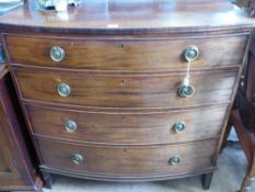 A Victorian Mahogany Bow Fronted Chest of Drawers. The chest having four graduated drawers, on