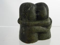 An Antique Inuit Soapstone Carving, depicting two lovers kissing, indistinct signature to base.