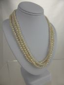 A Three Strand Cultured Pearl Necklace.