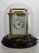 An Antique Brass Carriage Clock. The carriage clock having white enamel face, original key, under