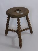 An Antique Stool, with Ace of Spades design cut into the surface, bobbin legs and three stretchers