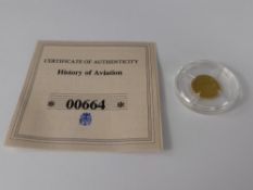 A .585 Solid Gold "Concorde Commemorative Coin", approx 0.5 gms with the original certificate, nr