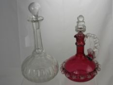 A Cranberry Decanter with shell design frill around the middle dating from the 19th Century,