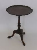 A Mahogany Occasional Wine Table, with scalloped top and tri-pod base.