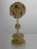 An Antique Carved Ivory Puzzle Ball on stand, the puzzle ball measuring approx 7 cms dia, stand 13