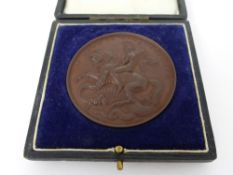 A Great War Bronze Medallion, awarded to Albert E Simmons for devoted service on the Poly Comforts