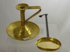 An Antique Brass Candle Holder, together with a pancake skillet. (2)