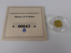 A .585 Solid Gold "History of Aviation-Spirit of St Louis" Coin, approx 0.5 gms, with the original