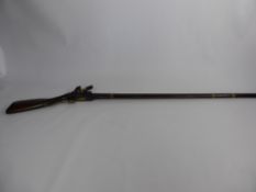 An Antique North African Flintlock Musket, with Continental influence, checkered wrist and scroll