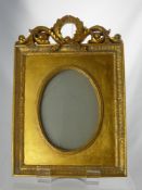 A Gilt Wood Photo Frame, having laurel scroll to top, approx 23 x 33 cms