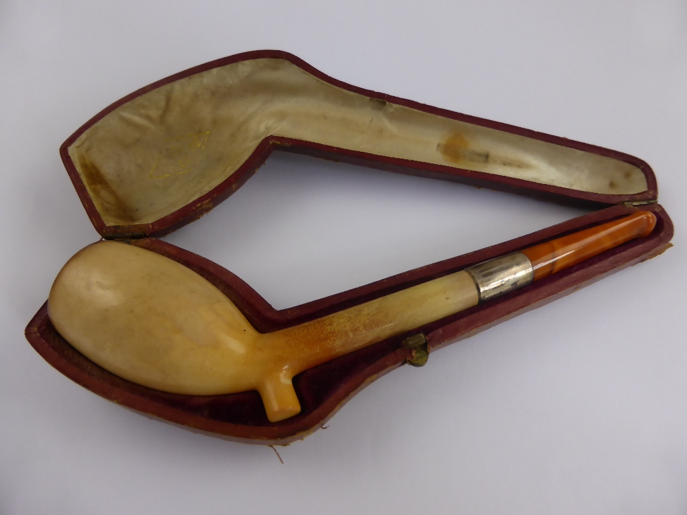 An Antique Meerschaum and Amber Pipe with silver collar in original box.