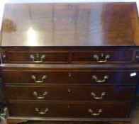 A Georgian Mahogany Drop Front Bureau, the bureau having split top with three graduated drawers,