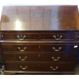 A Georgian Mahogany Drop Front Bureau, the bureau having split top with three graduated drawers,