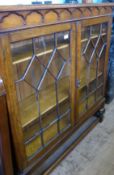 An Oak Astral-Glazed (Edwardian) Book Case, the book case of ecclesiastical style on bulbous