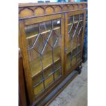 An Oak Astral-Glazed (Edwardian) Book Case, the book case of ecclesiastical style on bulbous