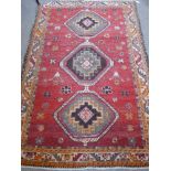 A Vintage Woollen Carpet, having three central medallions on orange ground, approx 140 x 200 cms.