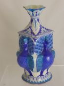 A 19th Century Persian Tin Glazed Stone Ware Vase, of peacock design, the vase having inverted