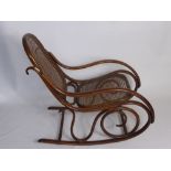 A Vintage Bentwood Rocking Chair with caned back and seat.