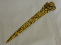 An Art Deco Brass Paper Knife, the handle with Pierrot design and floral engraved blade.