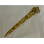 An Art Deco Brass Paper Knife, the handle with Pierrot design and floral engraved blade.