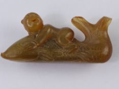 An Antique Chinese Figure of a Boy Riding a Fish. (WAF)