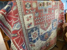 A Large Blue, Cream and Red Turkish Wool Carpet of geometric design, approx 290 x 170 cms.